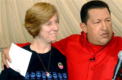 a smiling Cindy Sheehan with 

dictator Hugo Chavez