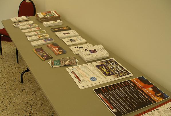 a table full of information brochures and posters.